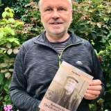 Paul Reeves holding his book