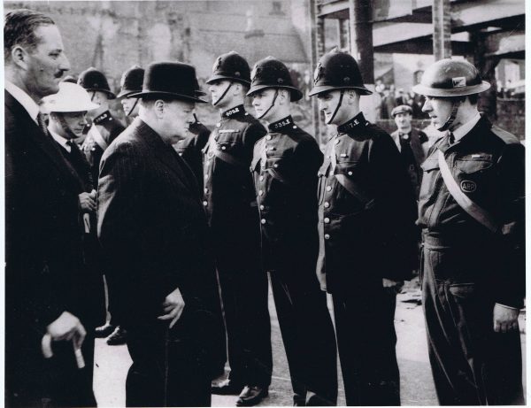black and white photograph of Winston Churchill inspecting police officers during WW2