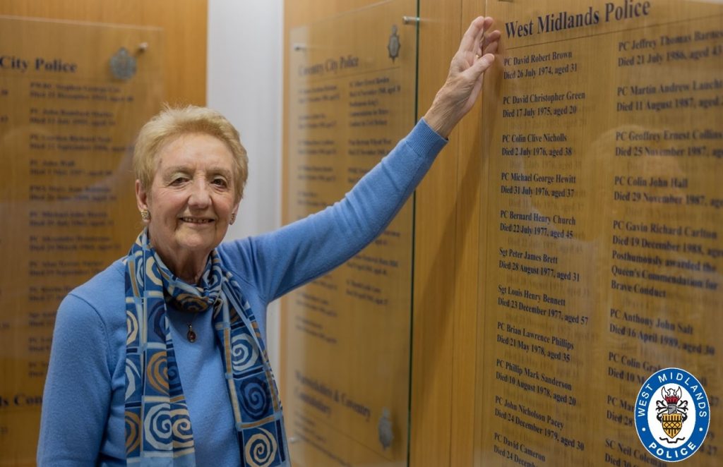 Photo of Linda next to the Roll of Honour