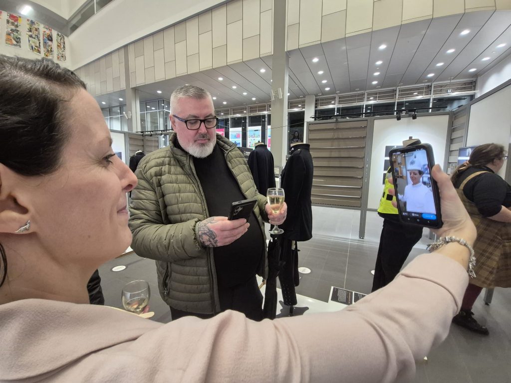 A woman uses an app called snapchat on her phone to see what she would look like wearing a police officers uniform
